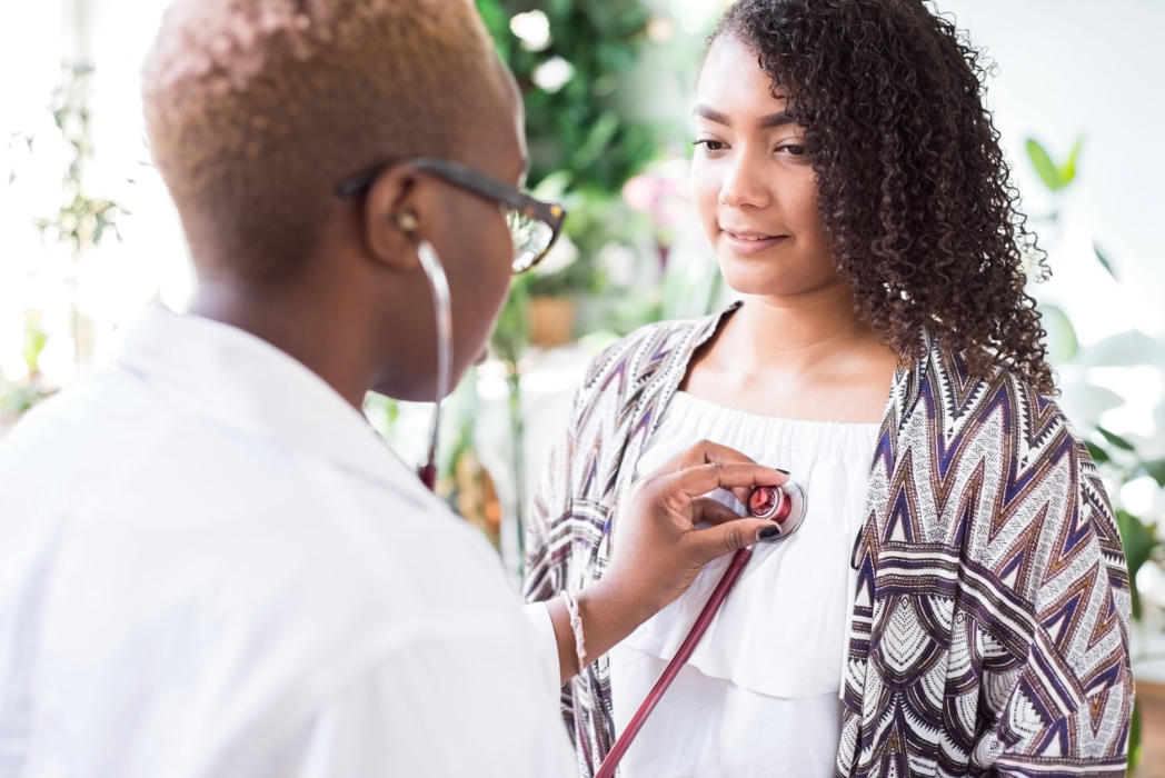 Preventative Care. Doctor checking patient heart beat.